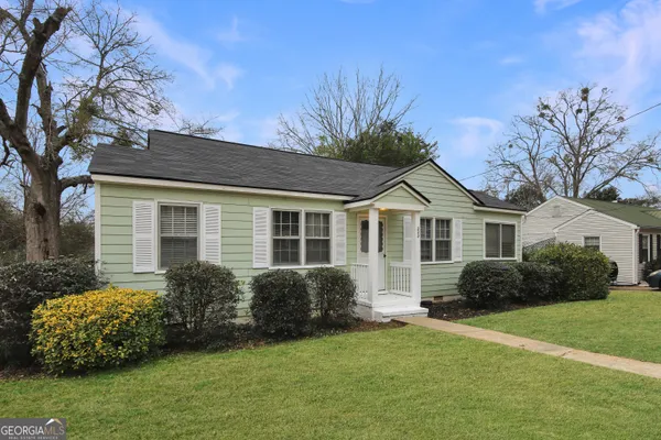 a front view of a house with a garden