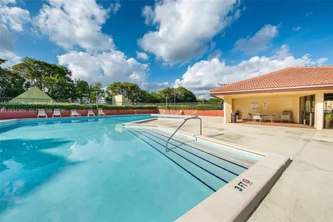 a view of a swimming pool with a yard