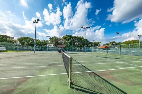 a view of a cars park in front of a building