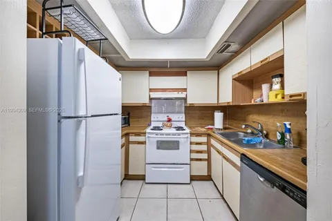 a kitchen with stainless steel appliances granite countertop a stove a refrigerator and a microwave