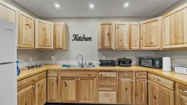 a kitchen with stainless steel appliances granite countertop a sink and dishwasher a stove with wooden cabinets