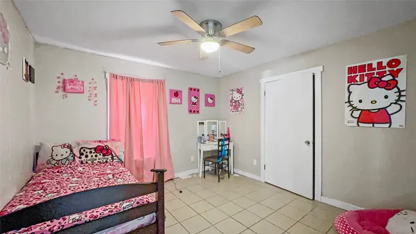 a bedroom with furniture and a chandelier fan