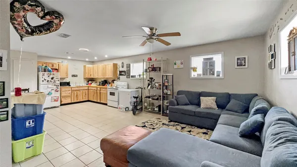 a living room with furniture and kitchen view