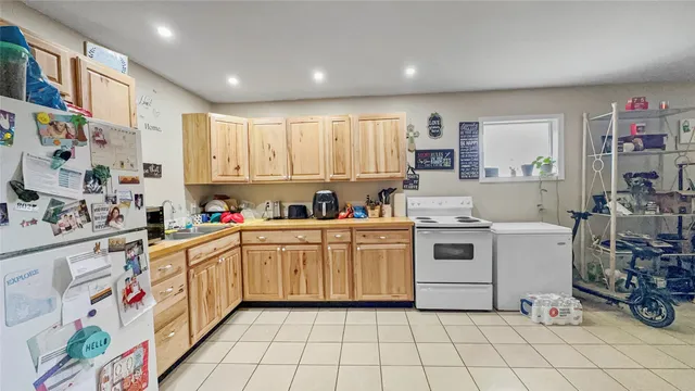 a kitchen with a sink a stove and cabinets