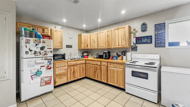 a kitchen with stainless steel appliances a stove a sink and a refrigerator