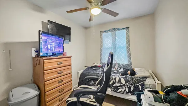 a view of a workspace with furniture and a fan