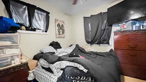 a bed sitting in a bedroom next to a window