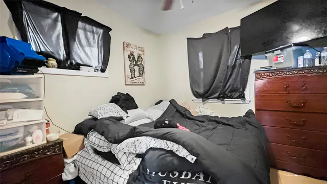 a bed sitting in a bedroom next to a window