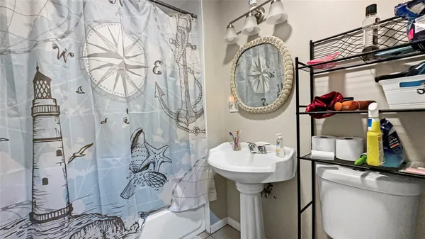 a bathroom with a sink mirror and vanity