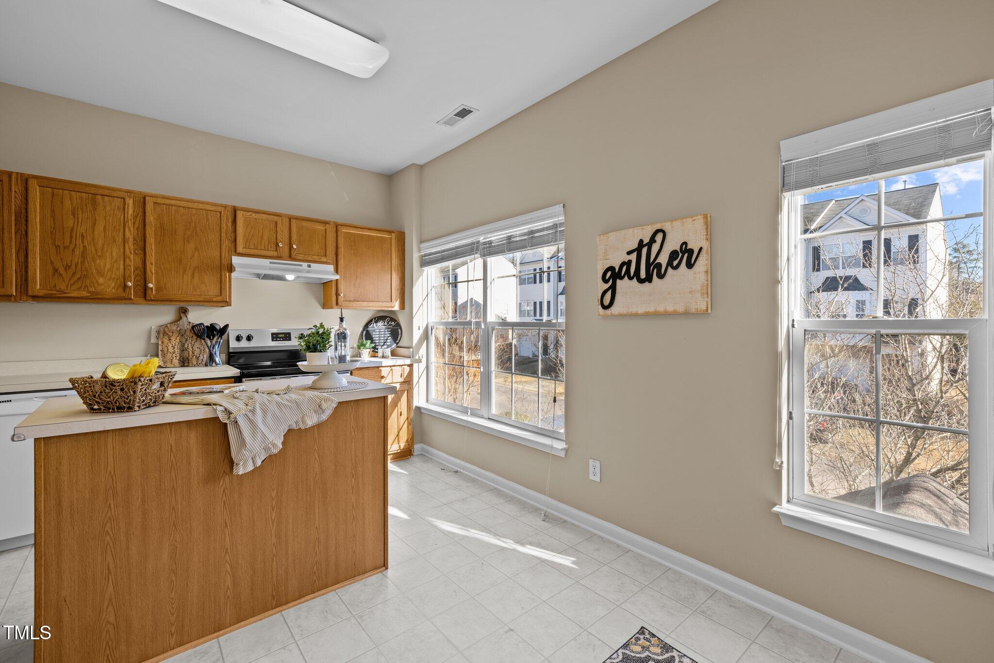 1674 Snow Mass Way Durham, NC 27713 - Photo 14 of 30 a living room with furniture a large window with kitchen view