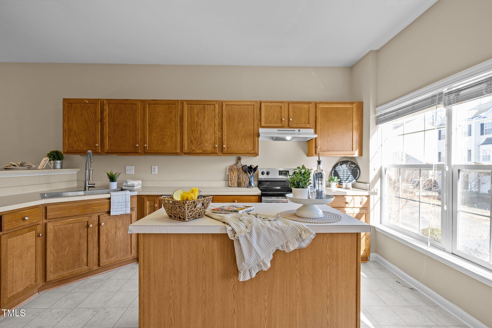 1674 Snow Mass Way Durham, NC 27713 - Photo 15 of 30 a kitchen with sink a window and cabinets
