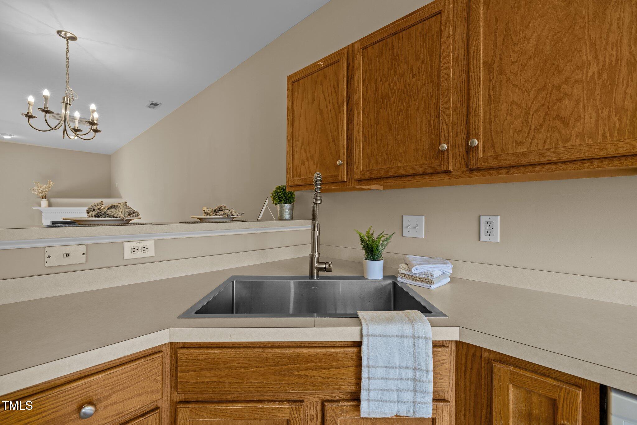 1674 Snow Mass Way Durham, NC 27713 - Photo 18 of 30 a kitchen with a sink cabinets and a stove top oven