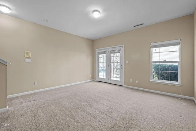 an empty room with windows and closet