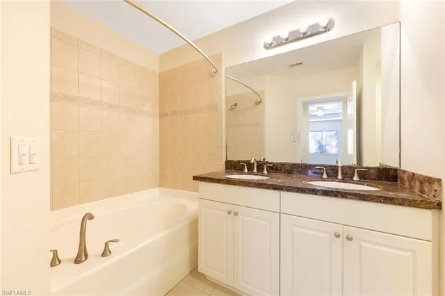 an empty room with a window and a ceiling fan