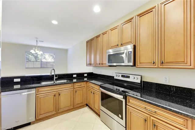 a bathroom with a granite countertop sink and a bathtub