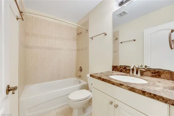 an empty room with a window and a ceiling fan