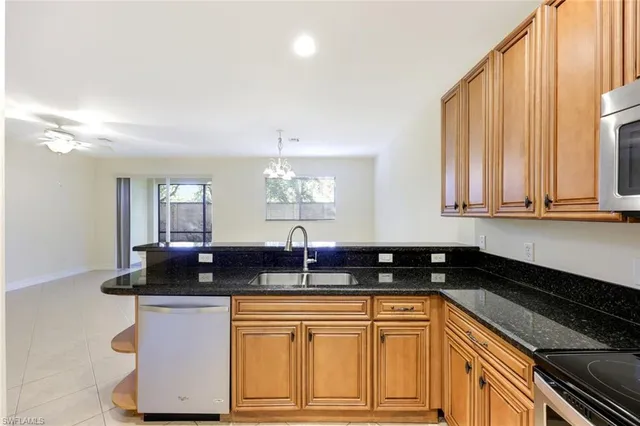 a view of a kitchen with a sink and a chandelier