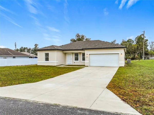 a very nice looking house with a big yard
