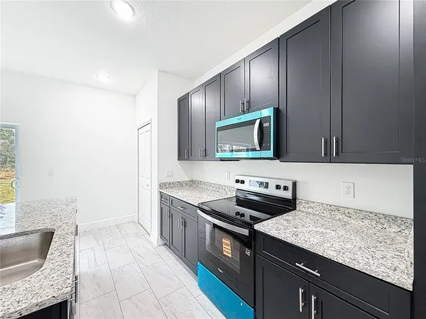 a kitchen with a sink stove and cabinets
