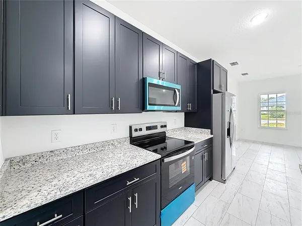 a kitchen with a sink stove and refrigerator