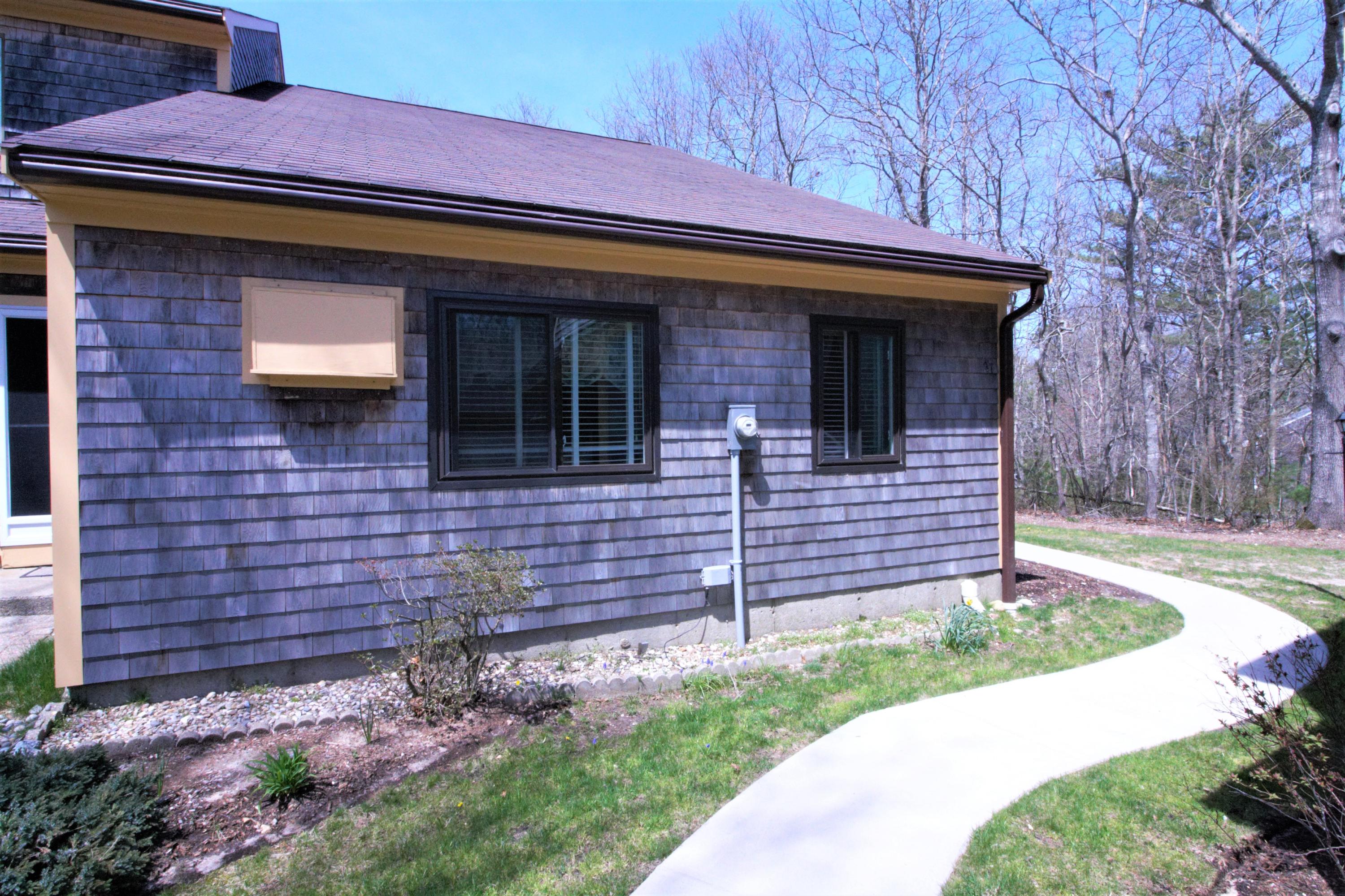 27 Round House Road Bourne, MA 02532 - Photo 3 of 13 a front view of a house with a garden