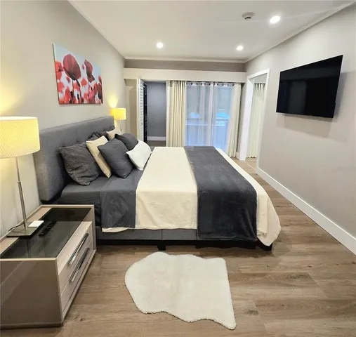 a bedroom with a bed and a flat screen tv