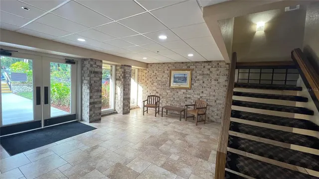 a lobby with furniture and stairs