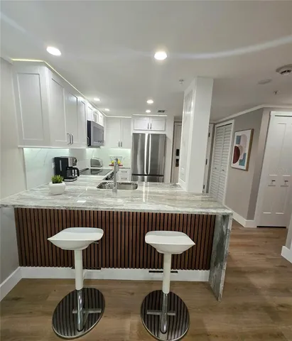 a kitchen with a dining table and chairs