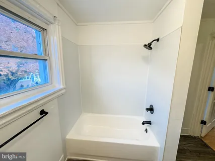 a bathroom with a bathtub and shower