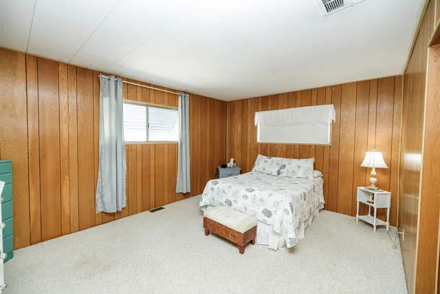 a bedroom with a bed and a night stand