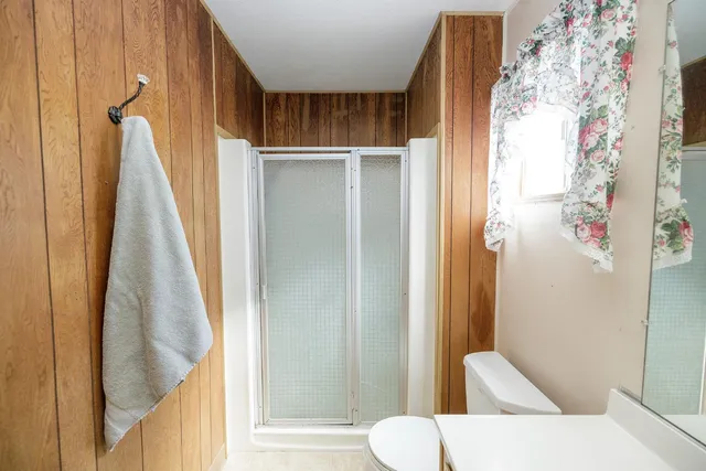 a bed room with a bed and a chair