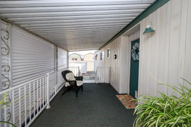 a balcony with furniture and a potted plant
