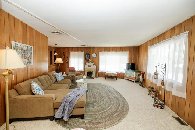 a bedroom with a bed and a large mirror on the dresser