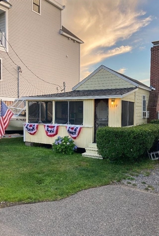 1177 Ferry Street Marshfield, MA 02050 - Photo 18 of 18 a front view of house with yard and outdoor seating
