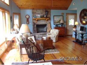 181 Caledonia Road Landrum, SC 29356 - Photo 11 of 24 a living room with furniture a fireplace and a table