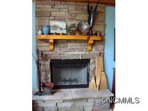 181 Caledonia Road Landrum, SC 29356 - Photo 24 of 24 a fireplace with a clock on wall