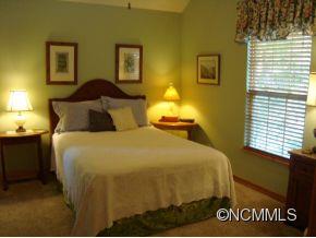 181 Caledonia Road Landrum, SC 29356 - Photo 5 of 24 a bedroom with a bed and lamps