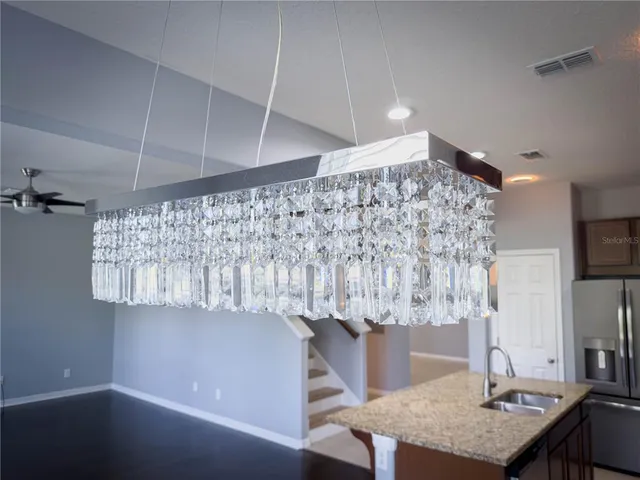a kitchen with stainless steel appliances a stove and more cabinets