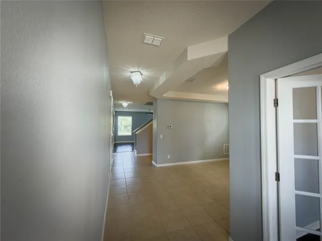 a view of wooden floor and windows in a room