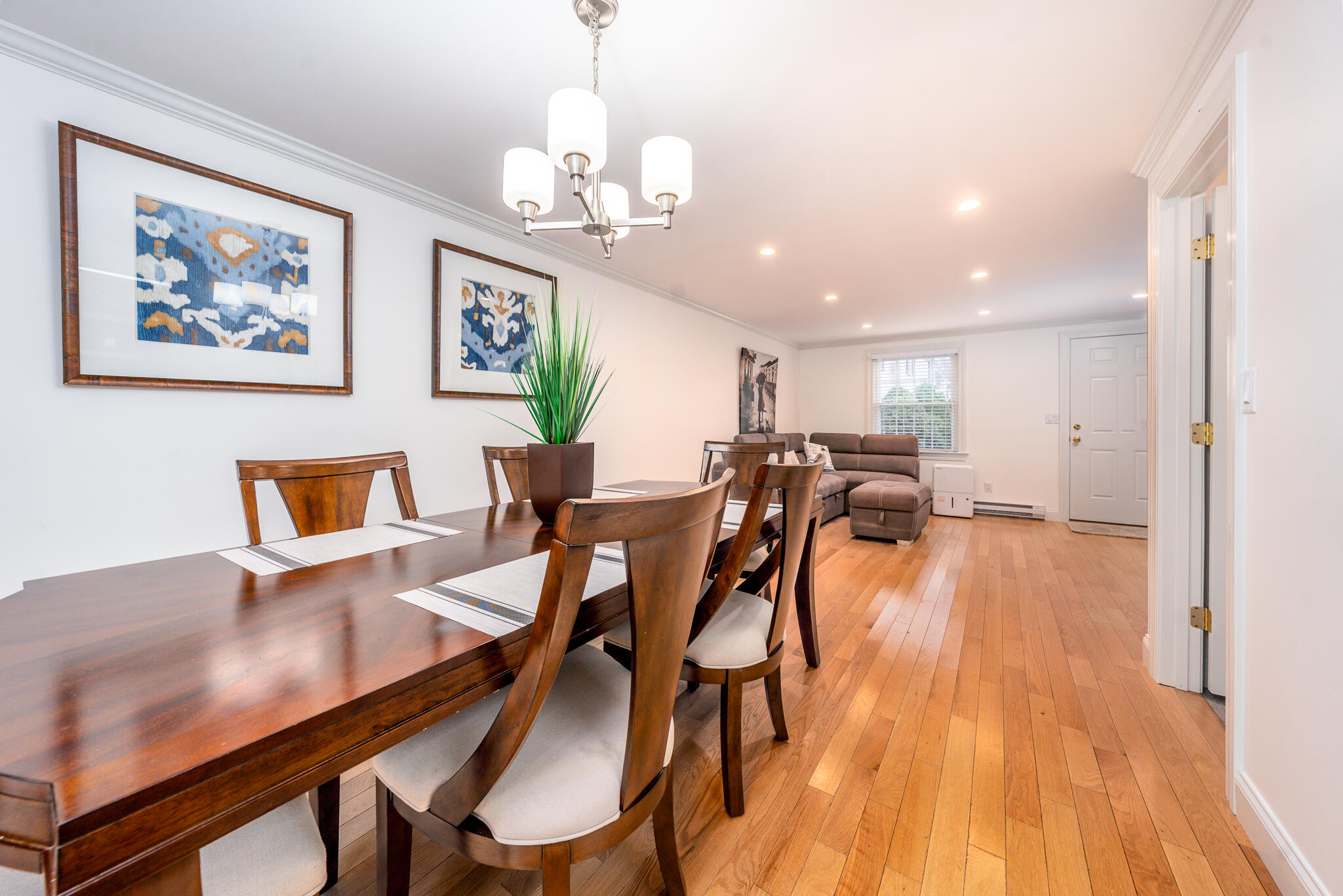 135 West Main Street, Unit 45 Hyannis, MA 02601 - Photo 12 of 23 a view of a dining room with furniture wooden floor and chandelier