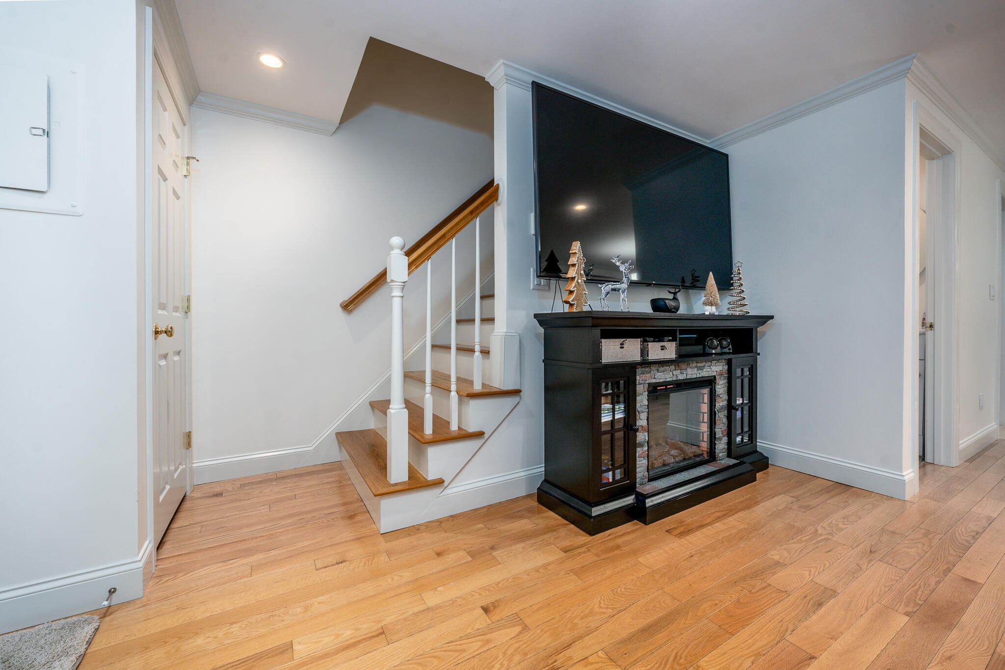 135 West Main Street, Unit 45 Hyannis, MA 02601 - Photo 14 of 23 a view of an empty room with stairs wooden floor and fire place