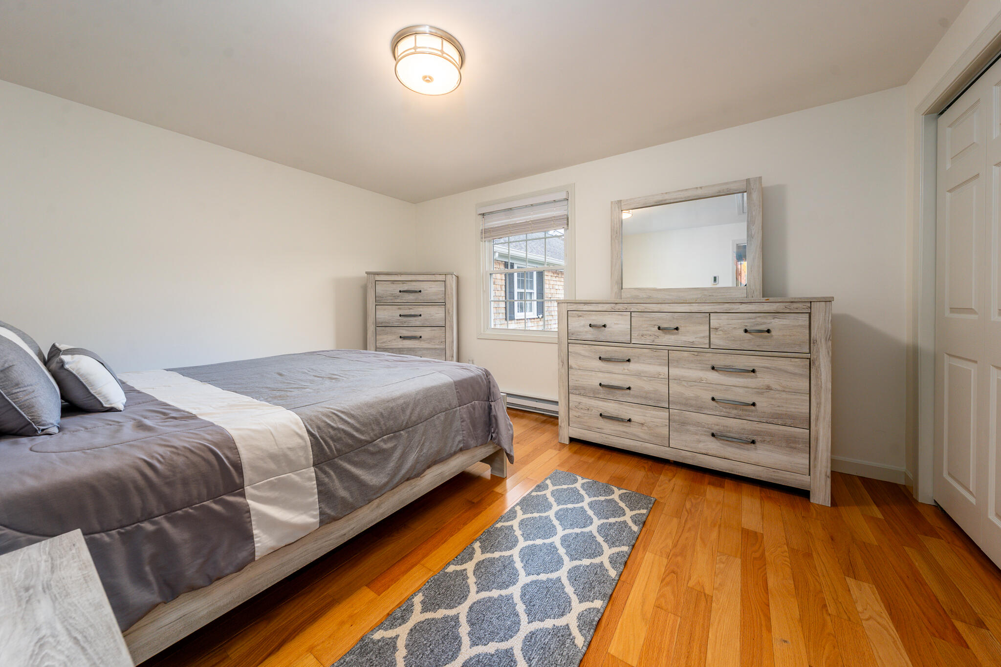 135 West Main Street, Unit 45 Hyannis, MA 02601 - Photo 16 of 23 a bedroom with a bed and a dresser