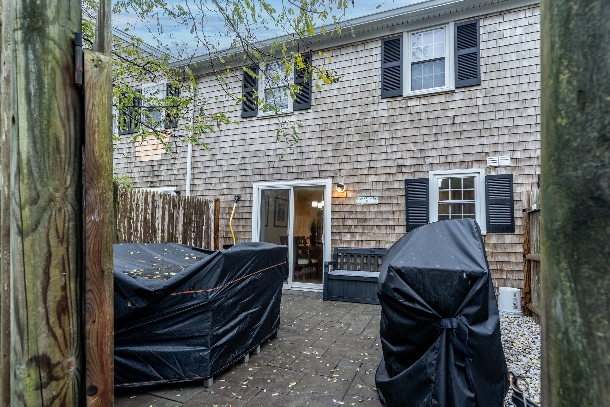 135 West Main Street, Unit 45 Hyannis, MA 02601 - Photo 21 of 23 a backyard of a house with barbeque oven table and chairs