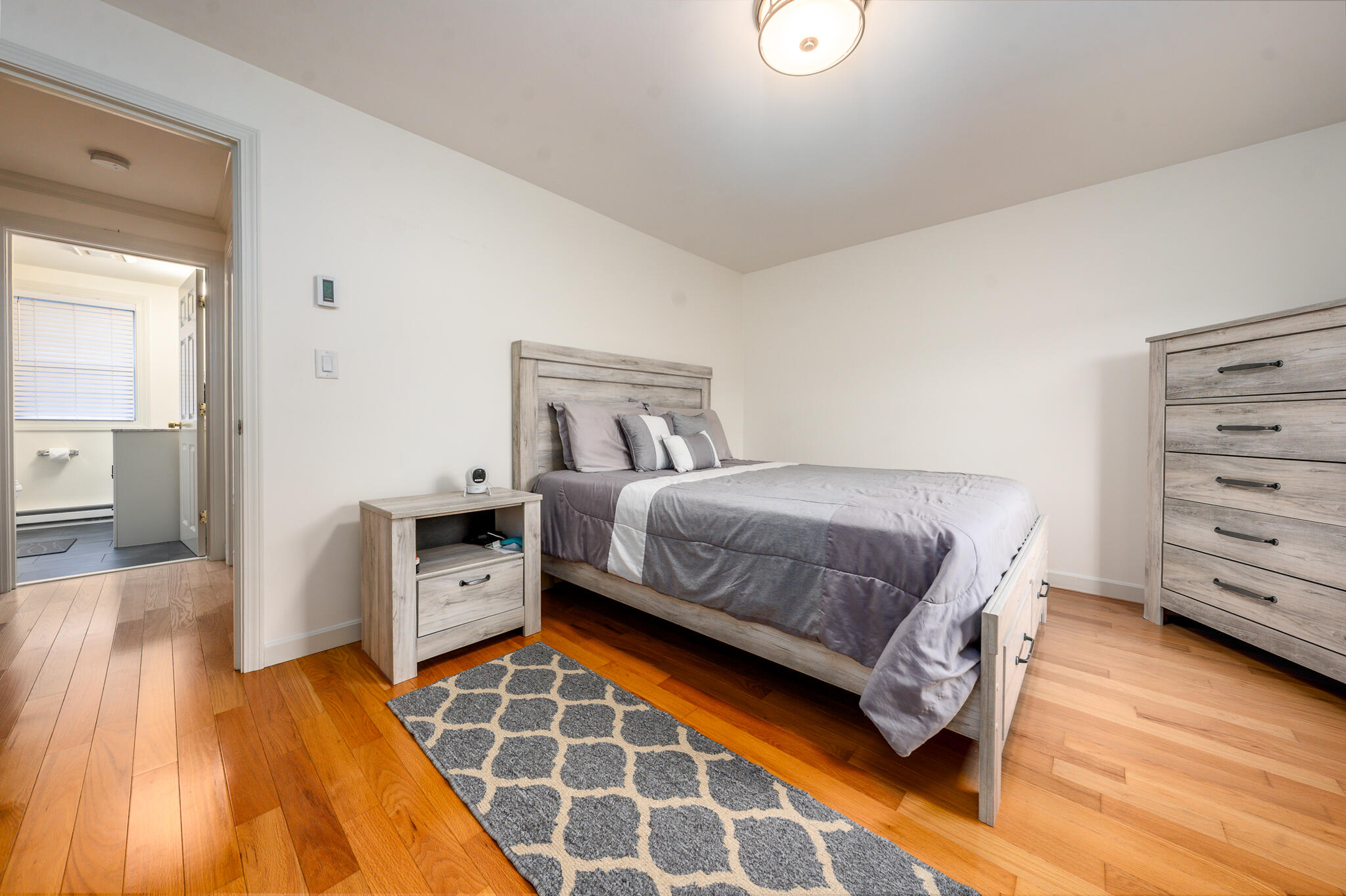 135 West Main Street, Unit 45 Hyannis, MA 02601 - Photo 4 of 23 a bedroom with a bed and wooden floor