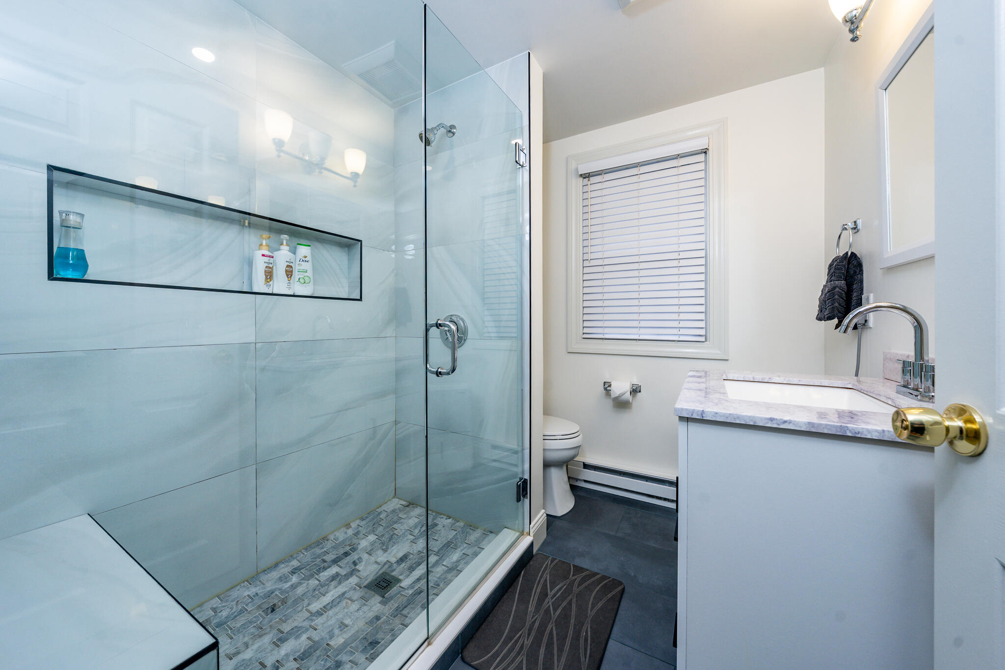 135 West Main Street, Unit 45 Hyannis, MA 02601 - Photo 5 of 23 a bathroom with a sink a toilet and shower