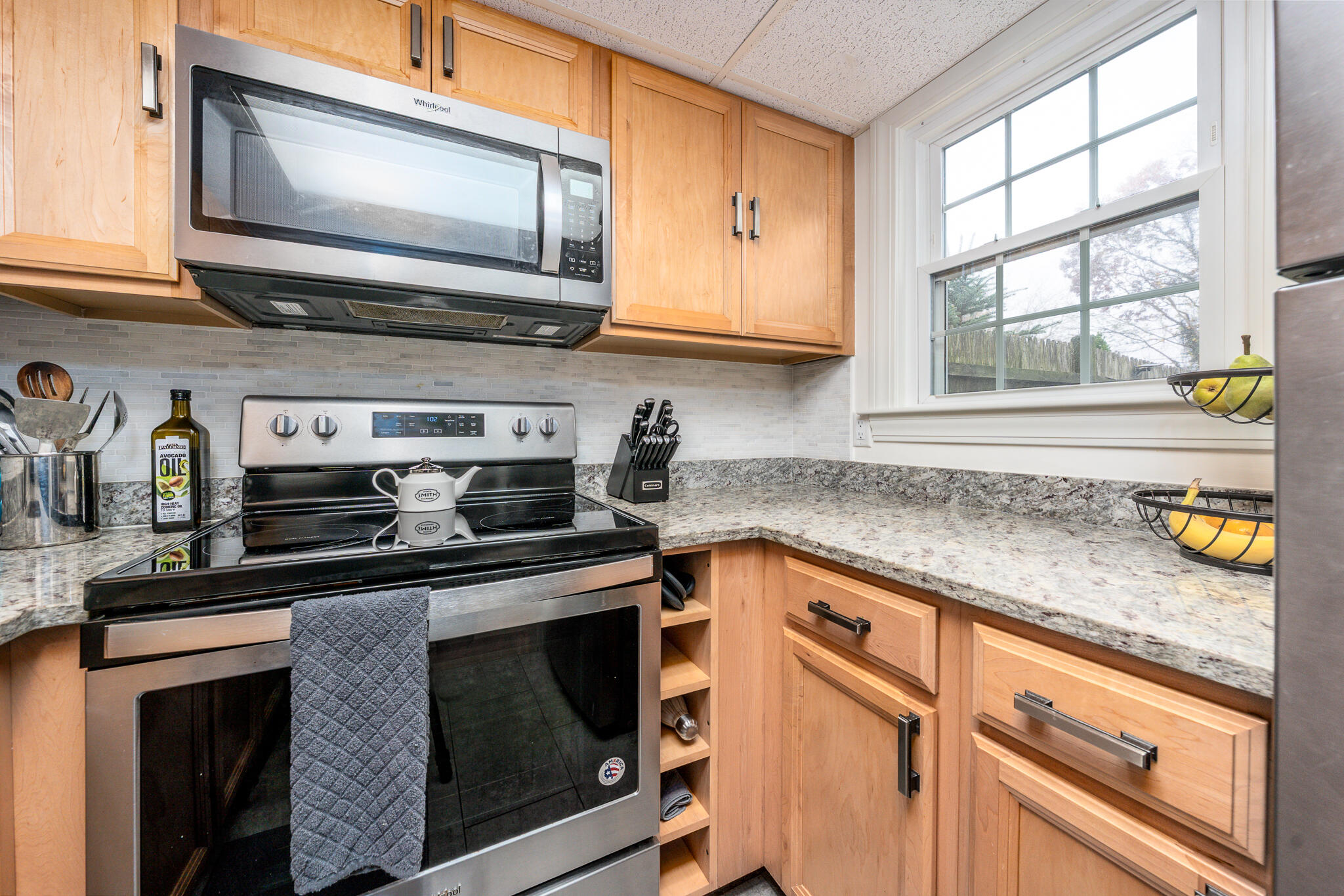 135 West Main Street, Unit 45 Hyannis, MA 02601 - Photo 8 of 23 a kitchen with stainless steel appliances granite countertop white cabinets and a window