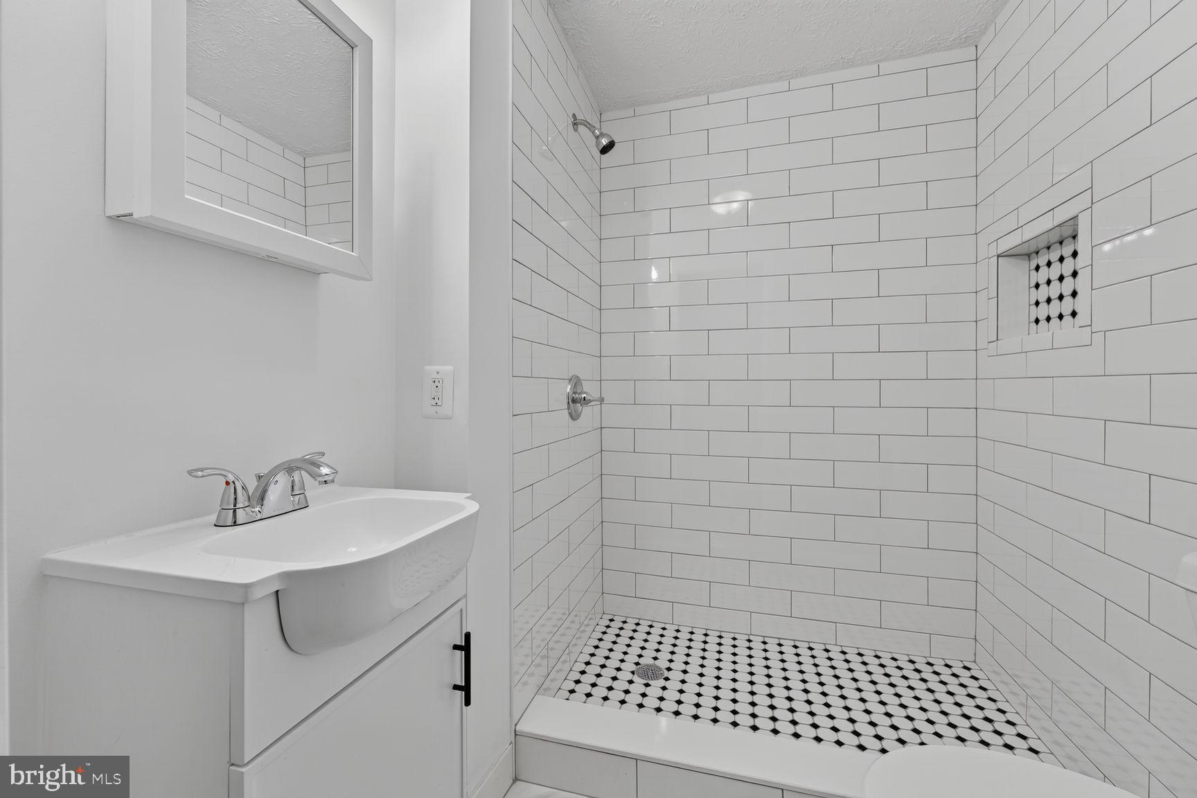4150 Sweetman Road Marbury, MD 20658 - Photo 11 of 33 Sleek modern shower with classic tiles - primary.