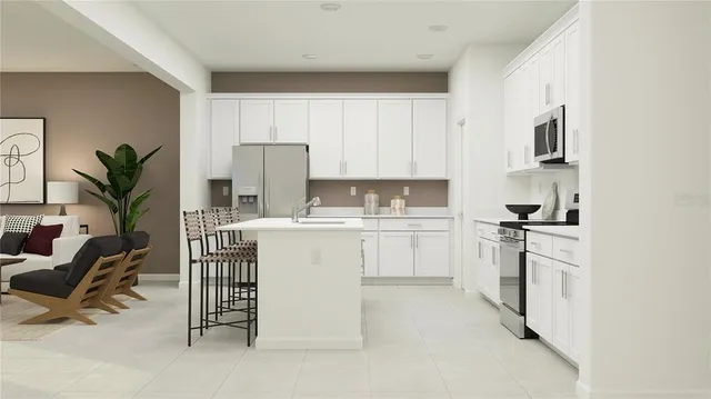 a kitchen with a refrigerator sink and white cabinets