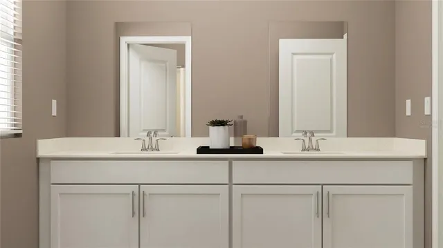 a bathroom with double sink and a mirror