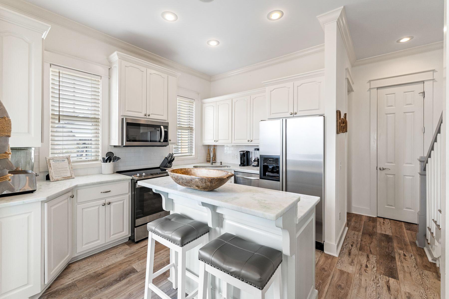 48 Chelsea Loop Road Santa Rosa Beach, FL 32459 - Photo 15 of 37 a kitchen with a sink a microwave a refrigerator and cabinets